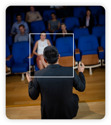 Speaker addressing a small audience in an auditorium