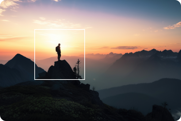 Hiker on a mountain peak during sunset