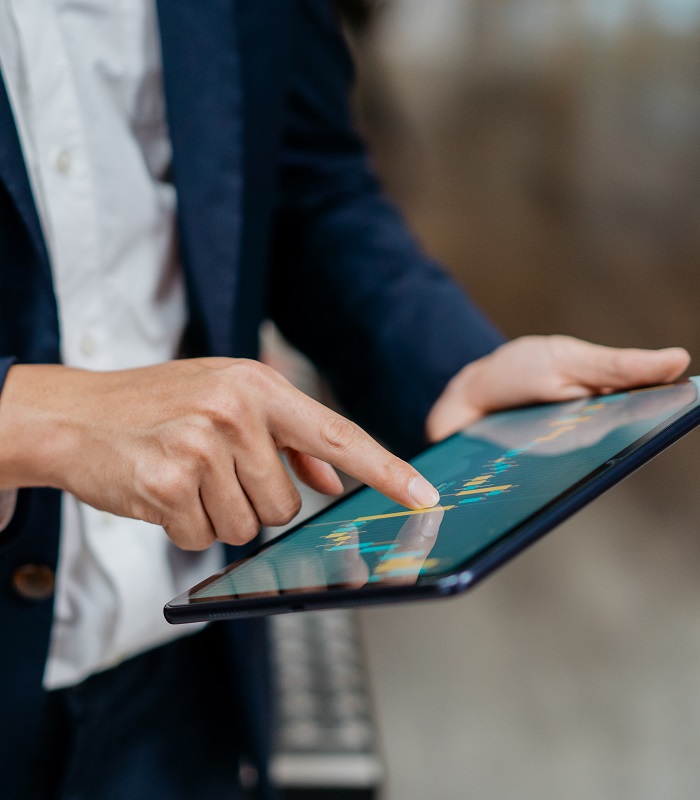Businessman analyzing stock chart on tablet