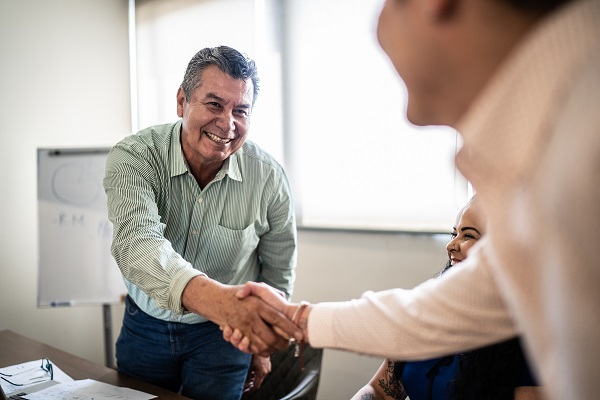 Coworkers shaking hands in an office