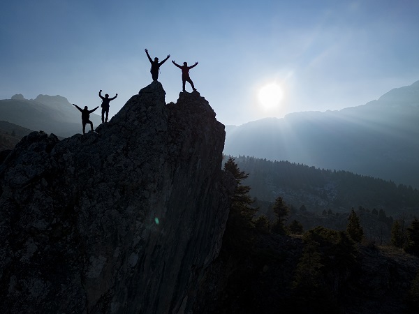 Group of hikers celebrating a successful climb to the summit