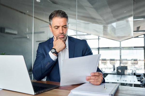 Businessman reviewing documents at his desk