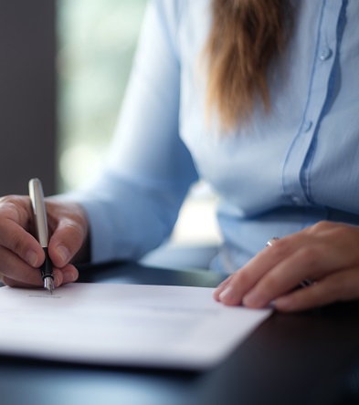 businesswoman signing a document