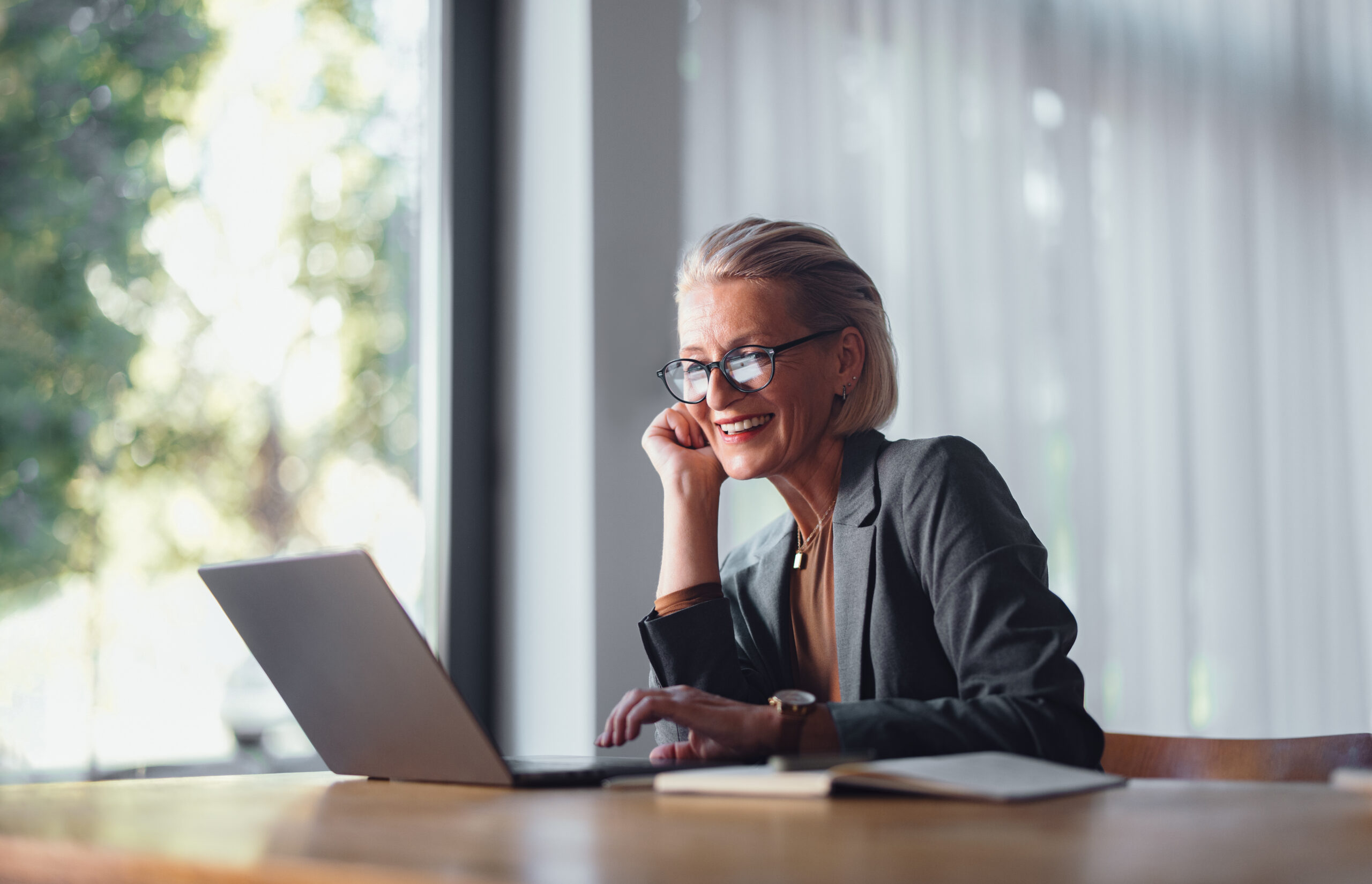 Smiling businesswoman working on a laptop
