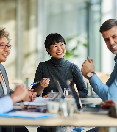 Group of happy entrepreneurs communicating during a meeting in the office.
