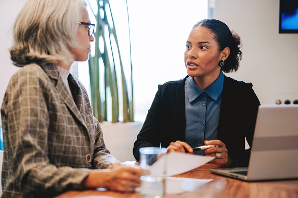 Two businesswomen talking in a meeting room