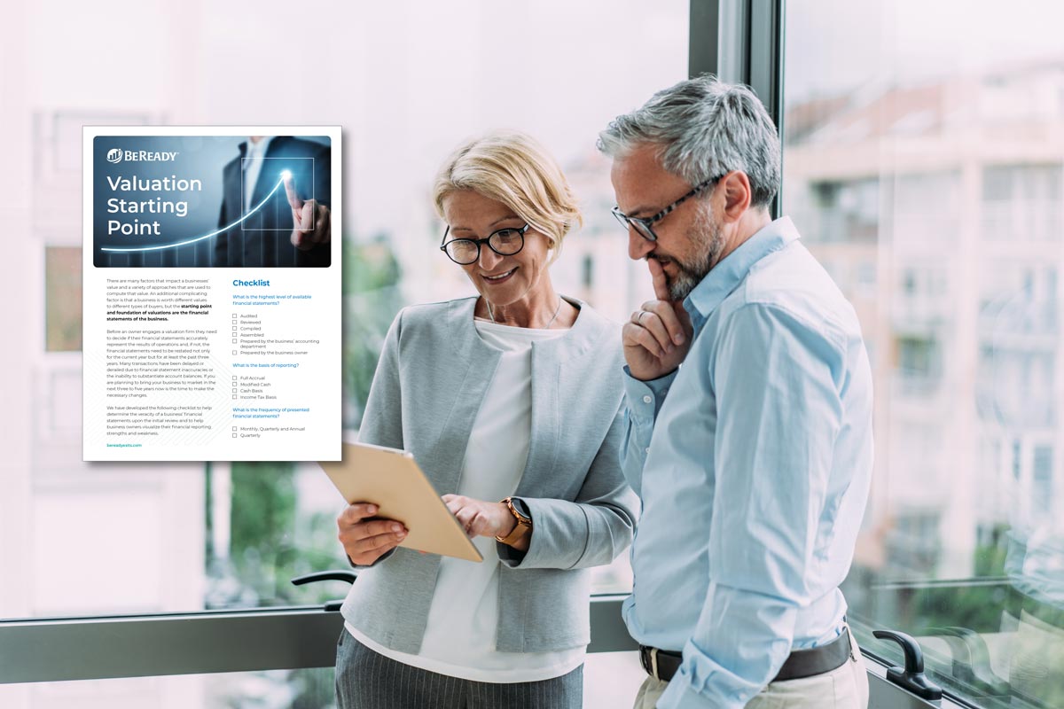 Two professionals reviewing a printed valuation checklist